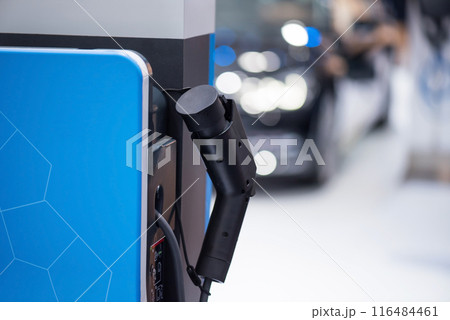 EV charging station with blur electric car. Vehicle power supply EV charging station with blur electric car. Vehicle power supply 116484461