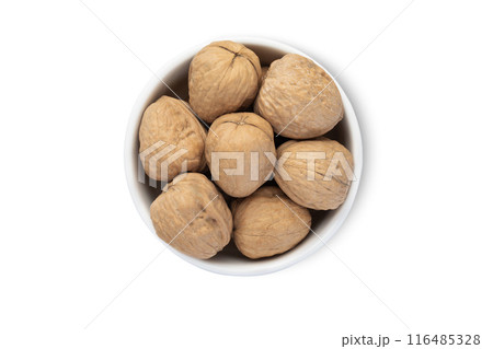 Ceramic bowl with organic walnut nuts with shell isolated on white background. 116485328