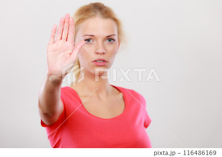 Woman showing stop gesture with open hand Woman showing stop gesture with open hand 116486169