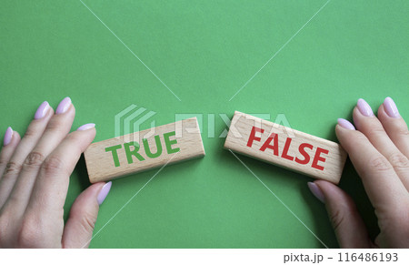 True or False symbol. Concept word True or False on wooden blocks. Businessman hand. Beautiful green background. Business and True or False concept. Copy space True or False symbol. Concept word True or False on wooden blocks. Businessman hand. Beautiful green background. Business and True or False concept. Copy space 116486193