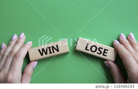 Win or Lose symbol. Concept word Win or Lose on wooden blocks. Businessman hand. Beautiful green background. Business and Win or Lose concept. Copy space 116486283