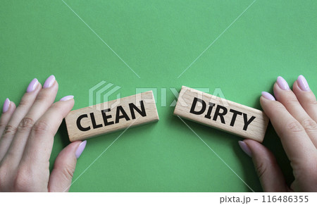 Clean or Dirty symbol. Concept word Clean or Dirty on wooden blocks. Man hand. Beautiful green background. Gender and Clean or Dirty concept. Copy space 116486355