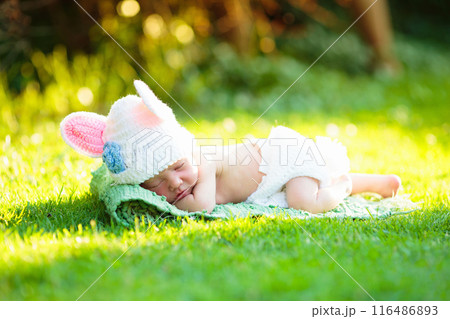 First Easter for baby boy. Kid and bunny. 116486893
