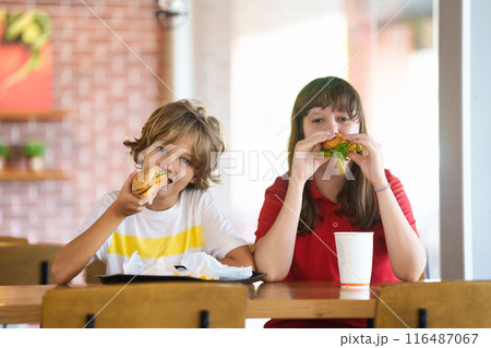 Kids eating fastfood. Unhealthy junk food. 116487067