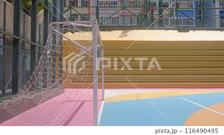 Colorful pink, blue, orane, soccer field and sport stands.in the urban town with building background Colorful pink, blue, orane, soccer field and sport stands.in the urban town with building background 116490495