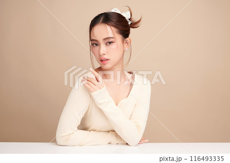 Beautiful young asian woman with clean fresh skin on beige background, Face care, Facial treatment, Cosmetology, beauty and spa, Asian women portrait. 116493335