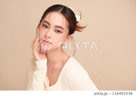 Beautiful young asian woman with clean fresh skin on beige background, Face care, Facial treatment, Cosmetology, beauty and spa, Asian women portrait. 116493336
