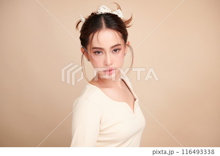 Beautiful young asian woman with clean fresh skin on beige background, Face care, Facial treatment, Cosmetology, beauty and spa, Asian women portrait. Beautiful young asian woman with clean fresh skin on beige background, Face care, Facial treatment, Cosmetology, beauty and spa, Asian women portrait. 116493338