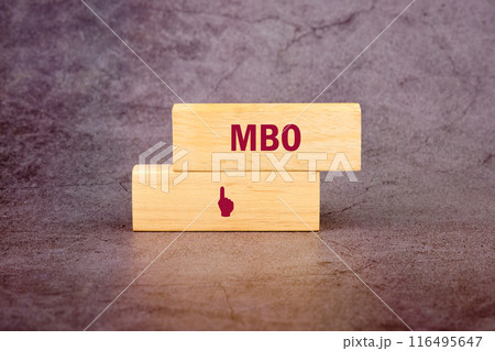 The letters MBO It is an abbreviation for Management by Objectives. MBO on wooden blocks on an abstract background The letters MBO It is an abbreviation for Management by Objectives. MBO on wooden blocks on an abstract background 116495647