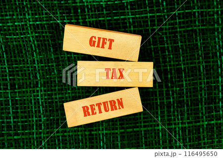 Financial research,government taxes and calculation tax return concept. GIFT TAX RETURN on wooden blocks, conceptual photo Financial research,government taxes and calculation tax return concept. GIFT TAX RETURN on wooden blocks, conceptual photo 116495650