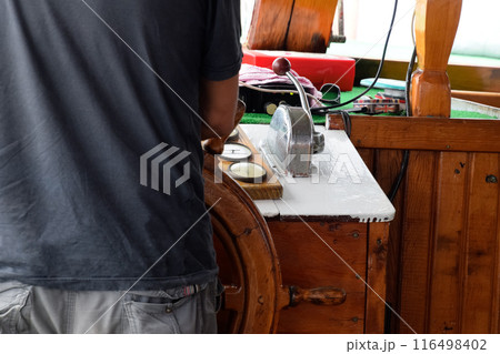 The captain of the ship at the helm The captain of the ship at the helm 116498402