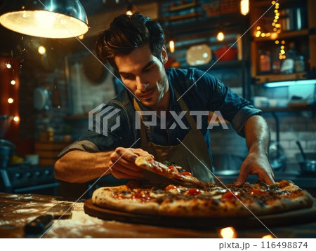 skilled chef wearing an apron meticulously adds delicious toppings to a freshly made pizza in a kitchen. 116498874