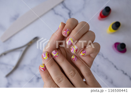 Stylish colorful summer female nails. Modern trendy stylish Beautiful manicure. Cute pastel nail minimalistic design concept of beauty treatment. Gel nails. Skin care 116500441