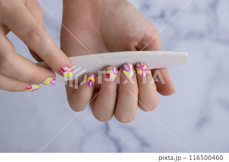 Manicure tools Woman manicured hands, stylish summer colorful nails. Closeup of manicured nails of female hand. Summer style of nail design concept. Beauty 116500460