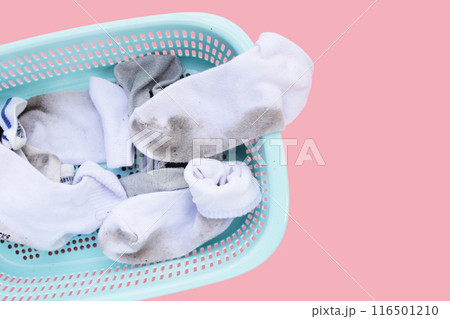 Dirty white socks in laundry basket 116501210