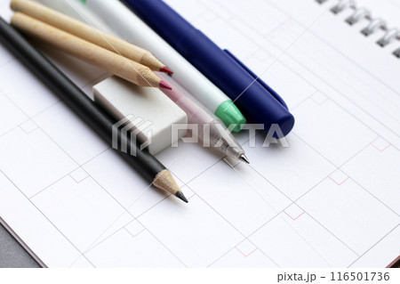 Calendar with pens and pencils. Planning concept Calendar with pens and pencils. Planning concept 116501736