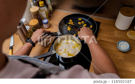 Chef at the kitchen preparing pumpkin porridge with tofu and vegetables 116502187