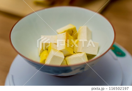 Chef at the kitchen preparing pumpkin porridge with tofu and vegetables 116502197