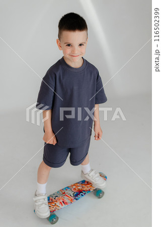 Full body little small smiling happy boy 5-6 years old wearing grey t-shirt look camera isolated on background studio Mother's Day love family lifestyle concept 116502399