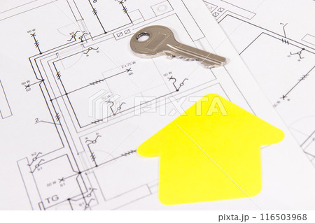 Construction drawing of electric installation, paper in shape of house and key 116503968