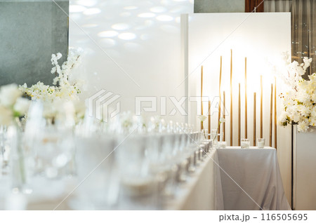 Elegant neutral coloured wedding table scape with flowers and candles Elegant neutral coloured wedding table scape with flowers and candles 116505695