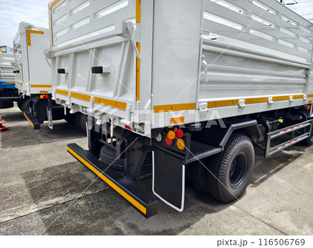 Two trucks are parked beside each other in a parking area 116506769