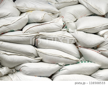 Stacking of big white bags in the modern warehouse Stacking of big white bags in the modern warehouse 116508533