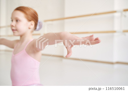 Young ballet girl at studio lesson. Training performance. Stretching exercise 116510061