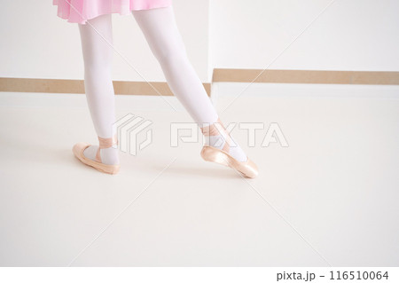 Young ballet girl at studio lesson. Training performance. Stretching exercise Young ballet girl at studio lesson. Training performance. Stretching exercise 116510064