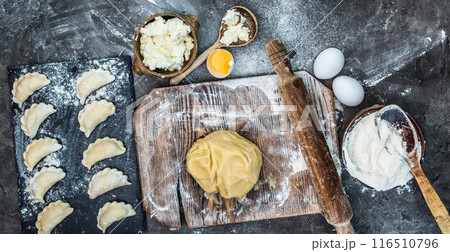 Top view of dough and varenyky on wooden board Top view of dough and varenyky on wooden board 116510796