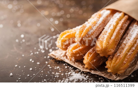 Closeup of churros  on rustic wooden background 116511399