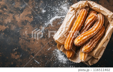 Closeup of churros  on rustic wooden background 116511402