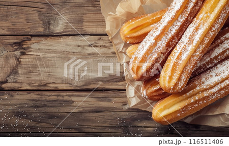 Closeup of churros  on rustic wooden background 116511406