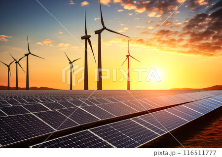Solar panels and wind turbines in a grassy field with sunlight 116511777
