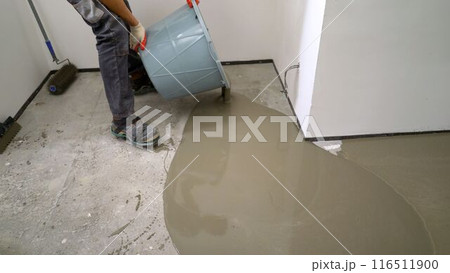 Floor renovation concept. Self-leveling floor is poured onto the floor, floor repair concept. Applying self leveling floor. Self-leveling floor. Floor renovation concept. Self-leveling floor is poured onto the floor, floor repair concept. Applying self leveling floor. Self-leveling floor. 116511900