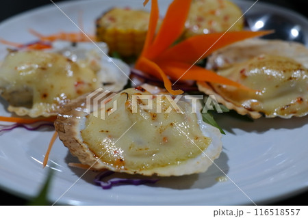 Grilled scallops on white plate in restaurant, close up 116518557
