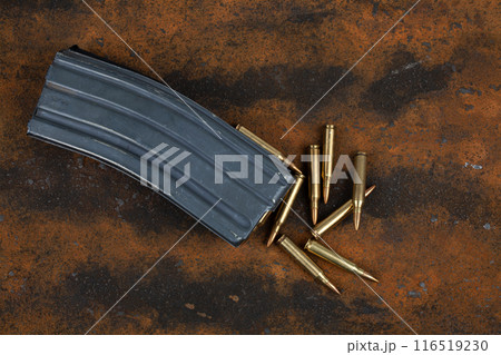 Ammunition with magazine on rusty metal 116519230