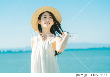 海と青空バックの麦わら帽子を被った女性 116519343