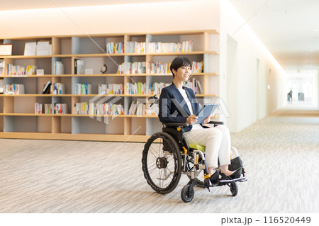 図書館で車椅子に乗っている若い女性 116520449