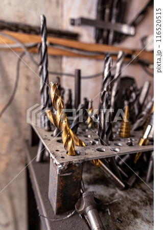 Close up of a golden metric drill bits. Home improvement or renovation. Selective focus Close up of a golden metric drill bits. Home improvement or renovation. Selective focus 116520515