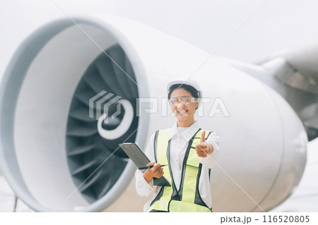 Technician fixing the engine of the airplane,Female aerospace engineering checking aircraft engines,Asian mechanic maintenance inspects plane engine 116520805