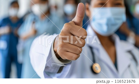 Healthcare professional giving thumbs up medical team background 116521676