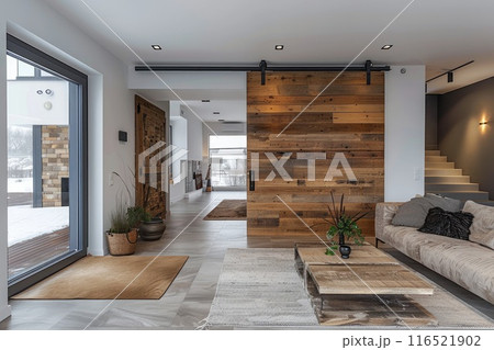 Modern home interior with a wooden sliding door. 116521902
