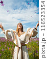 Beautiful woman relaxing on meadow with flowers 116523354