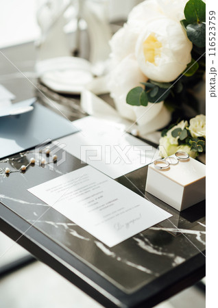 Wedding invitations. Wedding details of the bride. Bridal bouquet and other accessories. Shoes of the bride 116523759