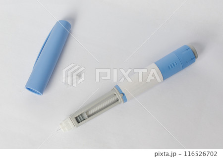 Blue Self injection pen with  insulin or semaglutide macro on white background. 116526702