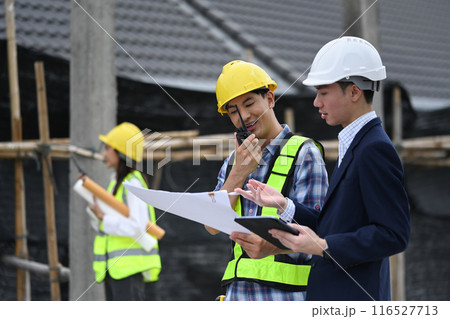 Engineers and businessman planning development details about project at construction site. 116527713
