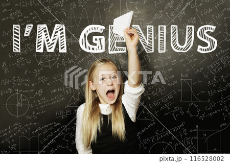 Genius schoolgirl child student against school blackboard background. Back to school concept Genius schoolgirl child student against school blackboard background. Back to school concept 116528002