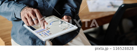 Website header shot of unrecognizable male hands holding tablet with launched app showing recent analytical analysis 116528828