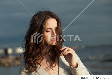 Gorgeous young lady brunette model on sea beach. Gorgeous young lady brunette model on sea beach. 116529799